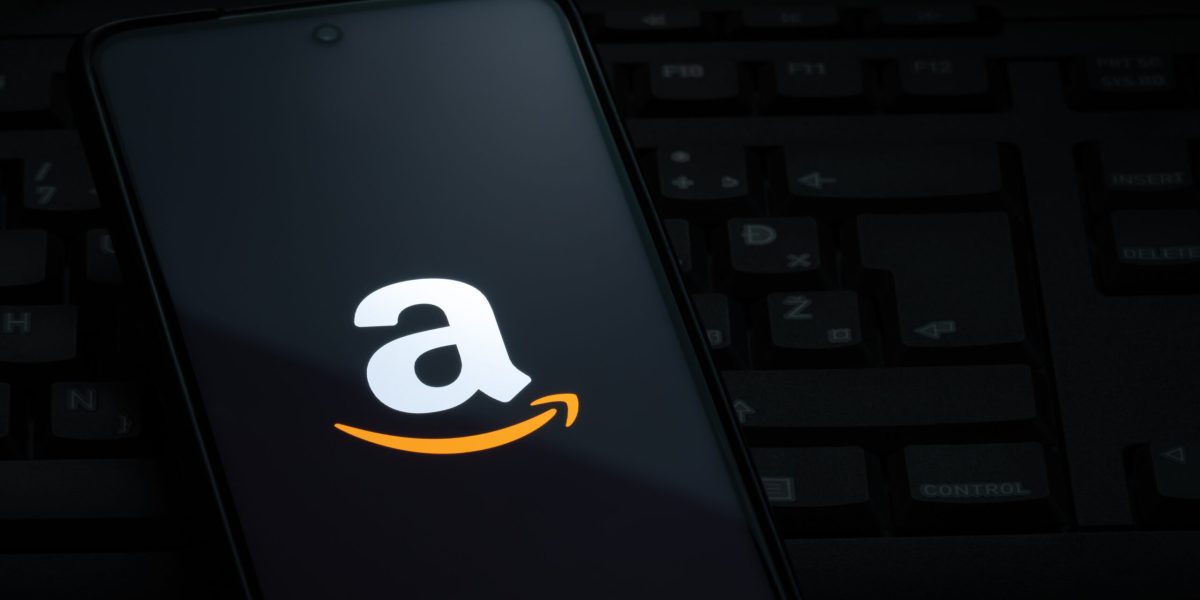 Ljubljana, Slovenia - 21 January 2023: Amazon logo on smartphone screen laying on computer keyboard