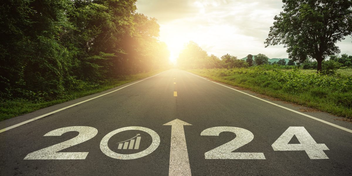 2024 Goal plan action, Business target and growth strategy. Business annual plan and development for achieving goals and success. 2024 written on the road in the middle of asphalt road with at sunset.